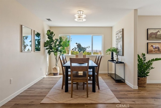 dining area with hardwood / wood-style floors