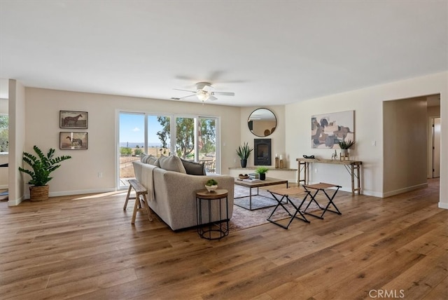 living room with ceiling fan and hardwood / wood-style floors