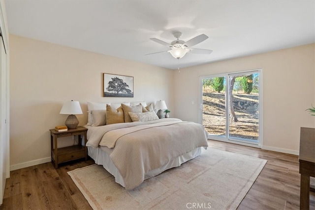 bedroom featuring hardwood / wood-style floors, access to outside, and ceiling fan