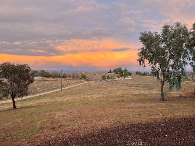 yard at dusk with a rural view