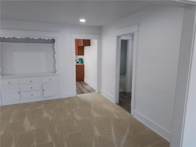 hallway with light colored carpet