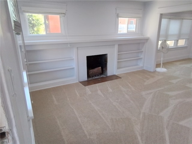 unfurnished living room with light colored carpet