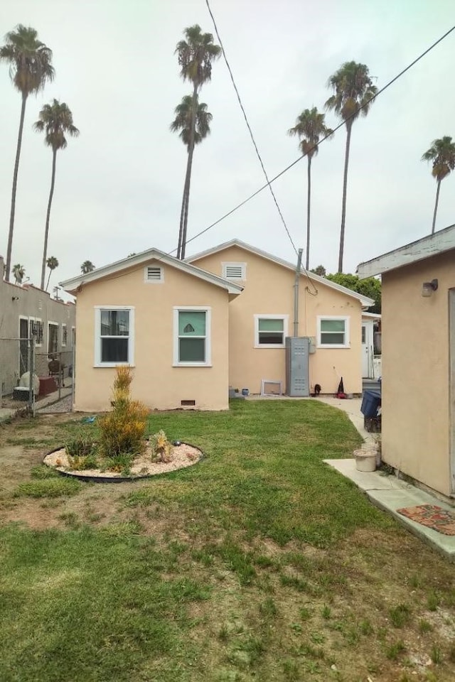 back of property featuring a lawn