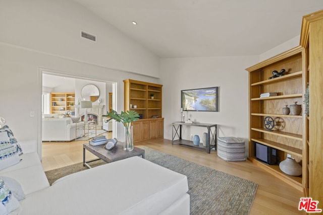 living room with lofted ceiling and light hardwood / wood-style floors