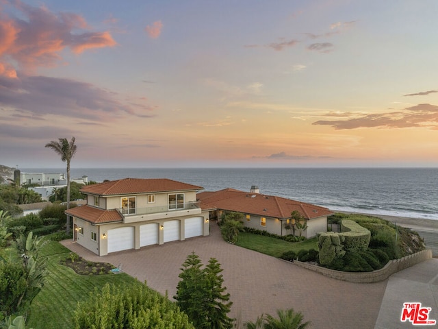 exterior space with a garage and a water view