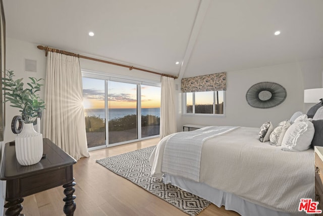 bedroom featuring lofted ceiling with beams, access to outside, and light wood-type flooring