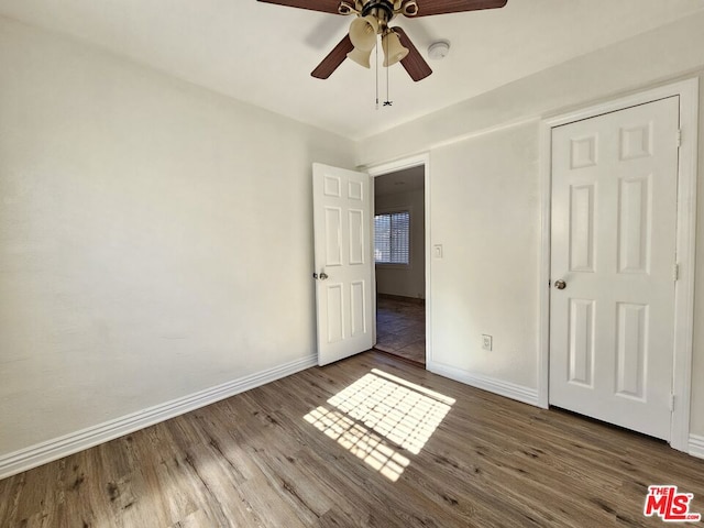 unfurnished bedroom featuring ceiling fan and wood-type flooring