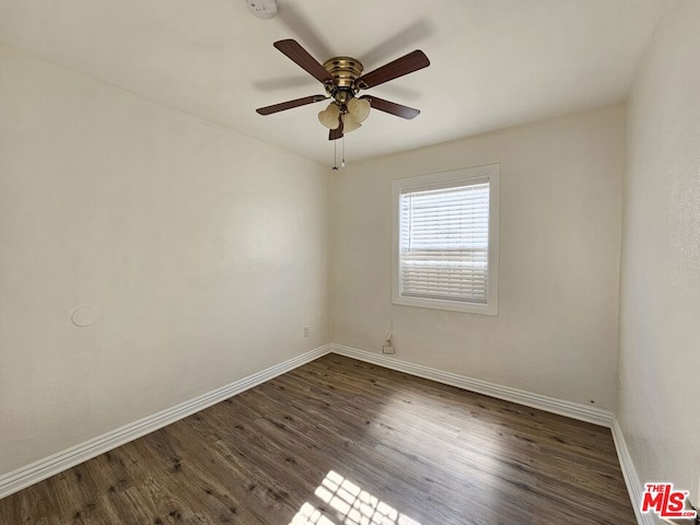 spare room featuring ceiling fan and dark wood-type flooring