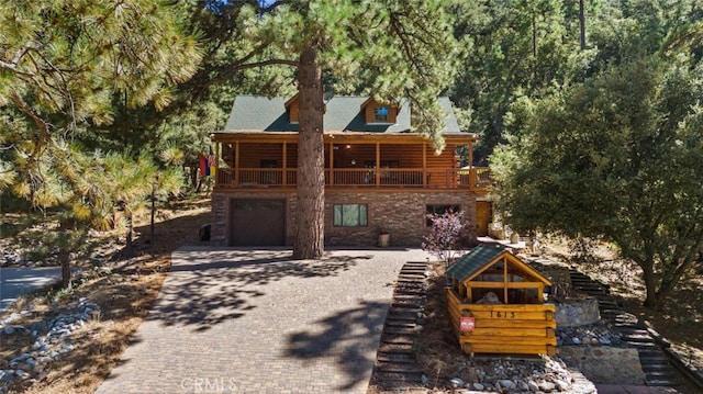 rear view of property featuring a garage