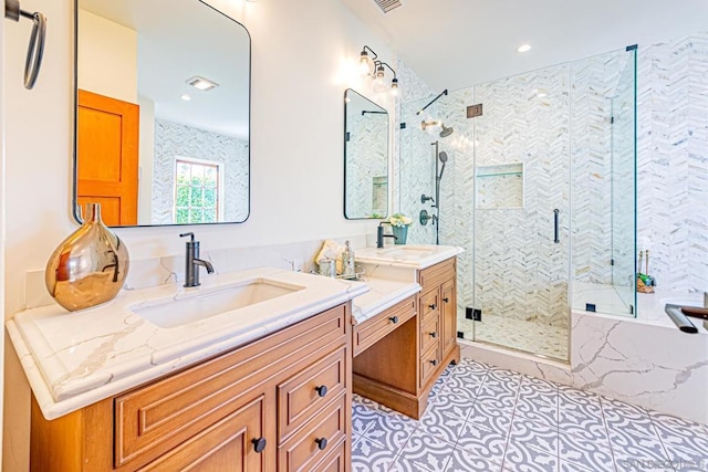 bathroom featuring tile patterned flooring, vanity, and a shower with shower door