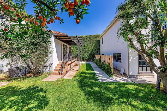 view of yard featuring a pergola and central AC unit