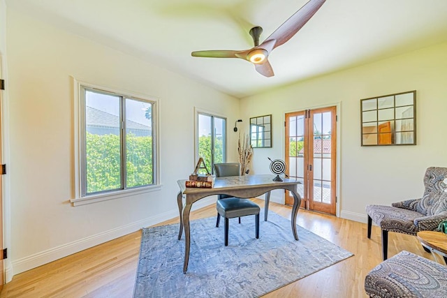 home office with french doors, light hardwood / wood-style floors, and ceiling fan