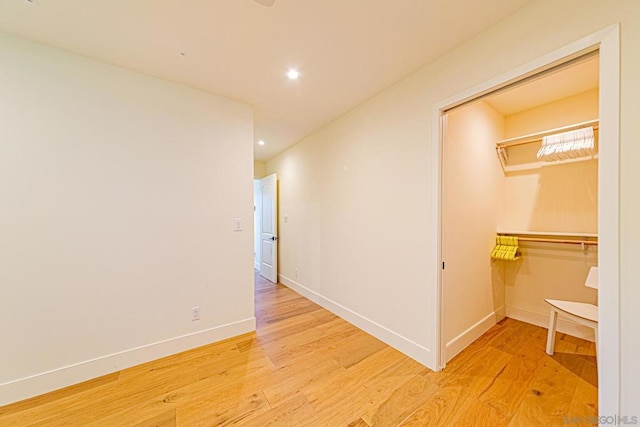 hallway with light hardwood / wood-style floors