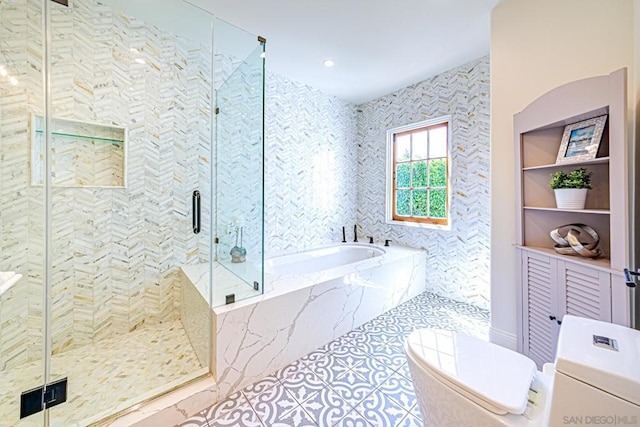 bathroom with tile patterned flooring, shower with separate bathtub, and toilet