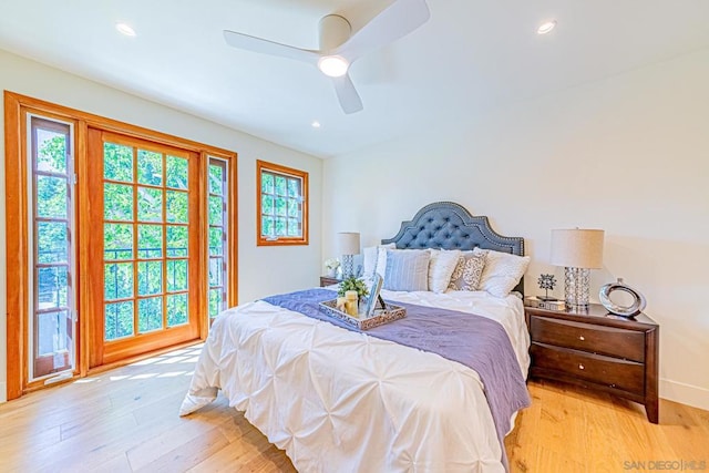 bedroom with multiple windows, ceiling fan, light hardwood / wood-style floors, and access to exterior