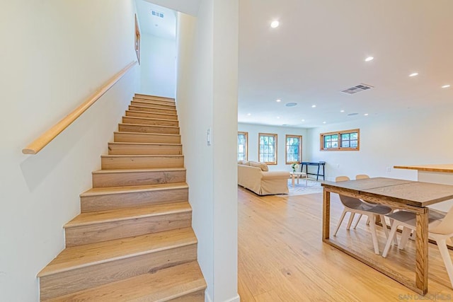 staircase with hardwood / wood-style floors