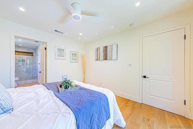 bedroom with light hardwood / wood-style floors, ensuite bath, and ceiling fan