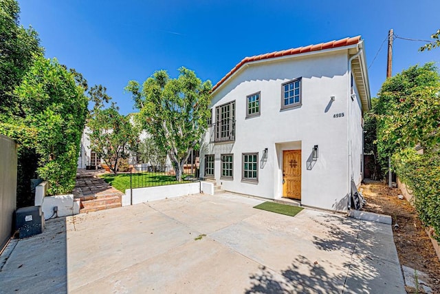 back of property with a patio