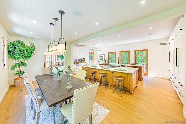 dining room featuring light hardwood / wood-style flooring and plenty of natural light