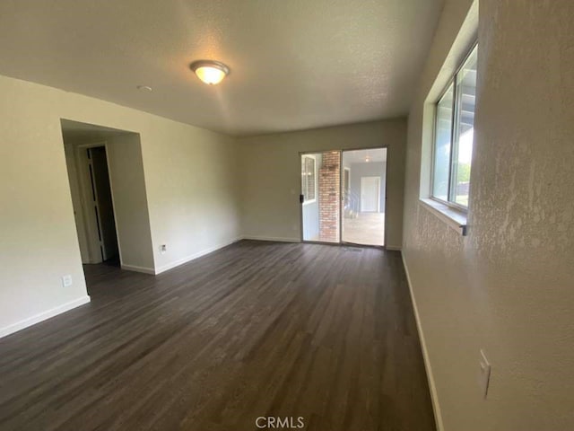 spare room with dark hardwood / wood-style flooring