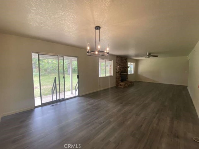 unfurnished living room featuring a fireplace, plenty of natural light, and dark wood-type flooring