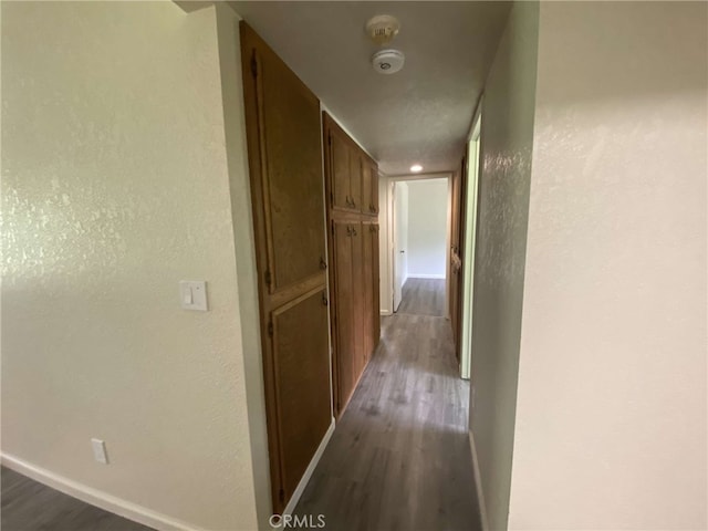 corridor featuring dark wood-type flooring