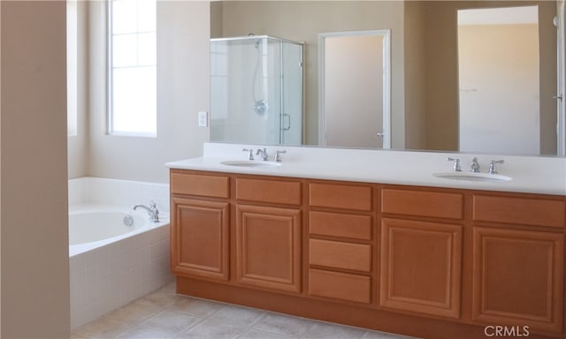 bathroom featuring tile patterned flooring, independent shower and bath, and vanity