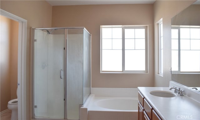 full bathroom with plus walk in shower, plenty of natural light, and toilet