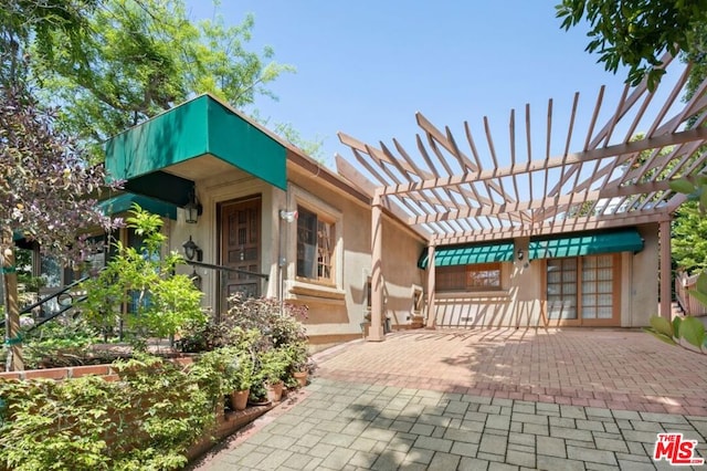 view of patio / terrace featuring a pergola and french doors