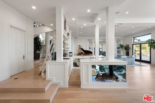 interior space with light hardwood / wood-style flooring and french doors