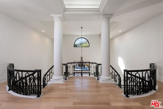 stairs featuring wood-type flooring and a chandelier