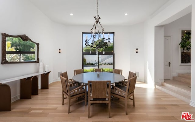 dining space with plenty of natural light, a notable chandelier, and light wood-type flooring