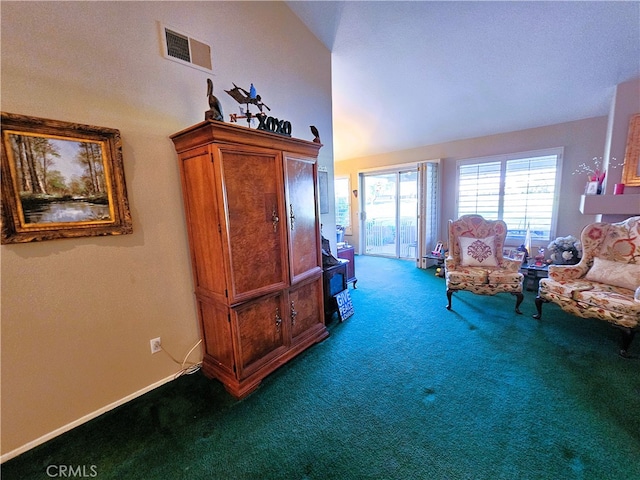 living area featuring carpet floors and vaulted ceiling