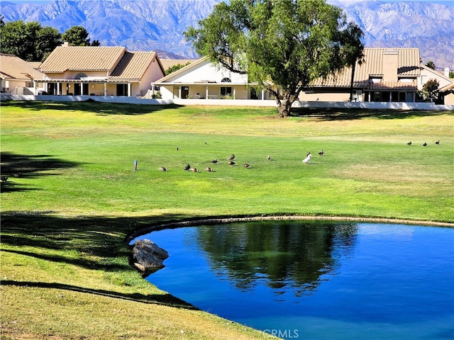 surrounding community featuring a lawn and a water and mountain view