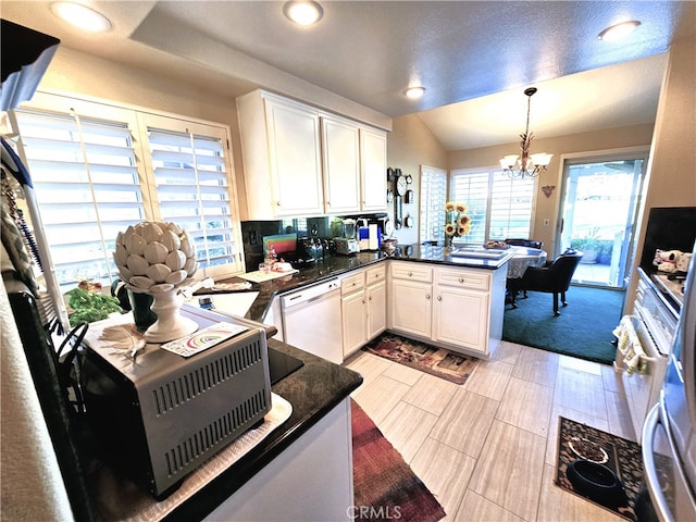 kitchen with white cabinets, dishwasher, pendant lighting, and kitchen peninsula