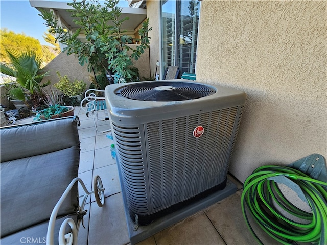 exterior details featuring cooling unit and tile patterned flooring