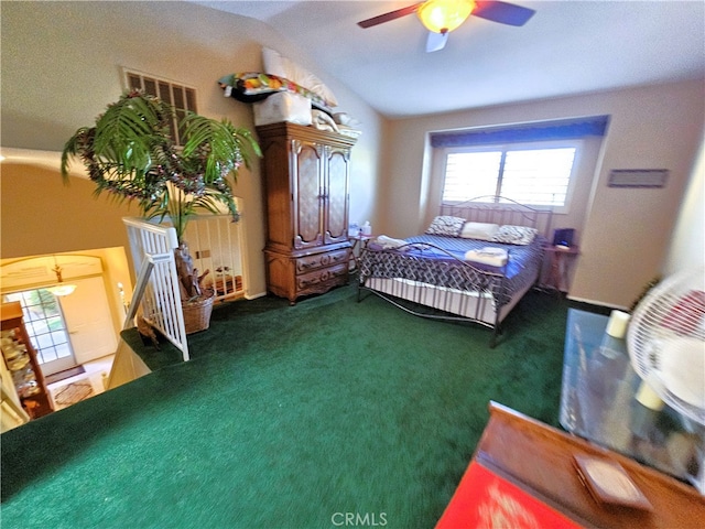 bedroom featuring ceiling fan, dark colored carpet, and vaulted ceiling