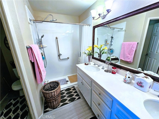 bathroom featuring vanity, toilet, and a shower with shower curtain