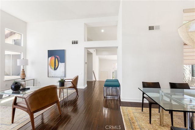 interior space with dark hardwood / wood-style floors and a high ceiling