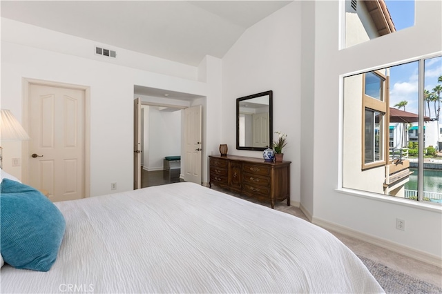 carpeted bedroom featuring vaulted ceiling