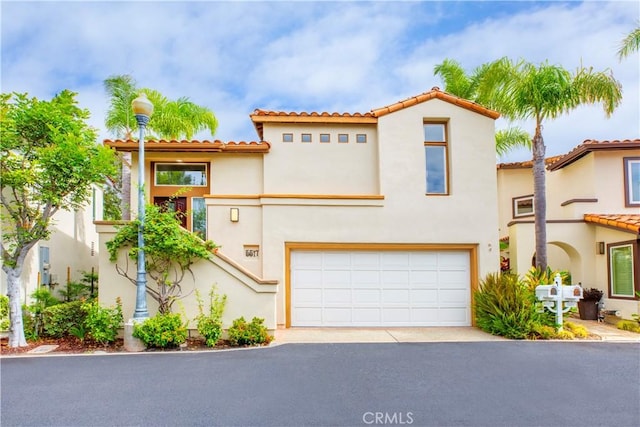 mediterranean / spanish home with a garage