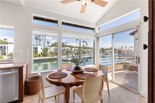 sunroom featuring ceiling fan, a water view, and vaulted ceiling