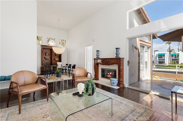 living room with dark hardwood / wood-style floors and high vaulted ceiling