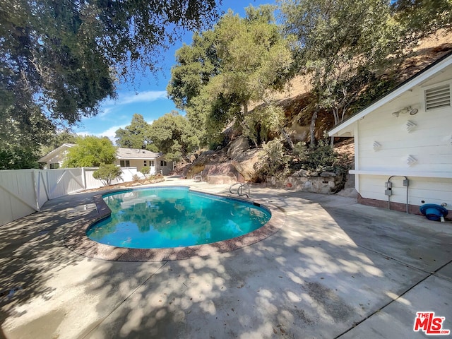 view of swimming pool featuring a patio area