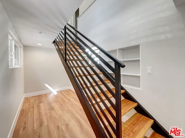 stairway featuring hardwood / wood-style flooring