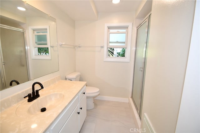 bathroom featuring walk in shower, vanity, and toilet