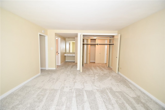 unfurnished bedroom with light colored carpet