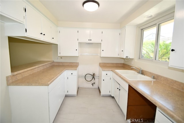 kitchen featuring white cabinets and sink