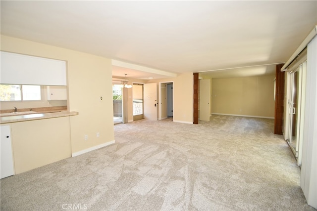 unfurnished living room with a healthy amount of sunlight and light colored carpet