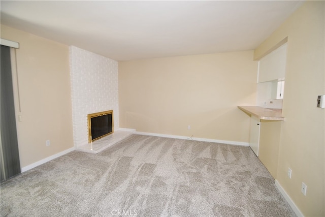 unfurnished living room featuring light colored carpet and a fireplace